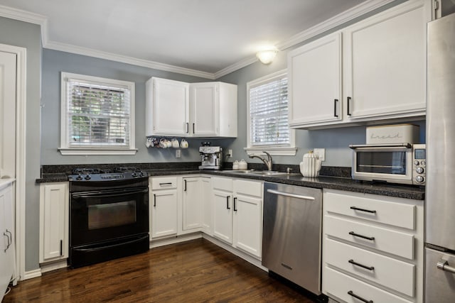 kitchen with dark wood-type flooring, stainless steel appliances, plenty of natural light, white cabinetry, and sink