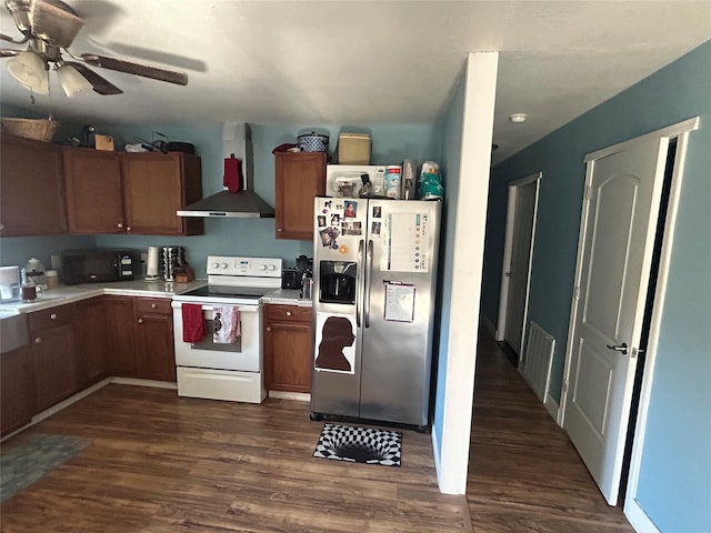 kitchen featuring dark wood-type flooring, stainless steel fridge, ceiling fan, white range with electric stovetop, and wall chimney range hood