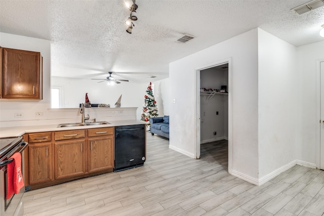 kitchen featuring black appliances, sink, ceiling fan, a textured ceiling, and light hardwood / wood-style floors