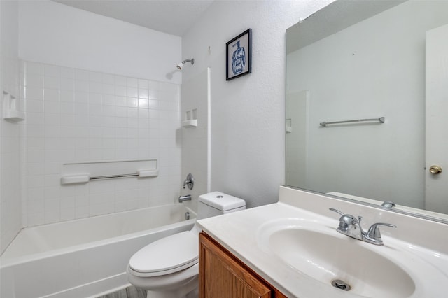 full bathroom with vanity, toilet, a textured ceiling, and tiled shower / bath combo