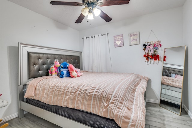 bedroom with ceiling fan and hardwood / wood-style floors