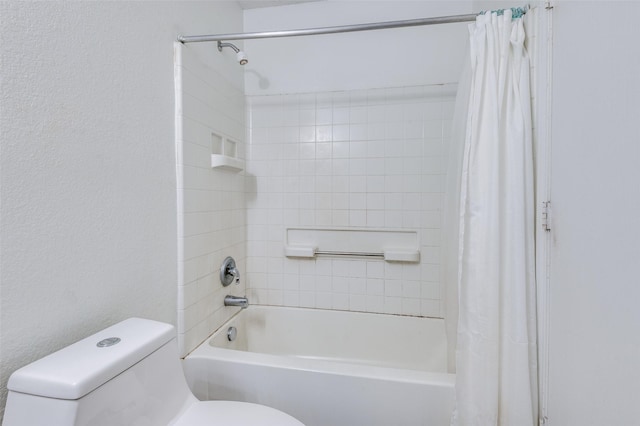 bathroom featuring shower / bath combo and toilet