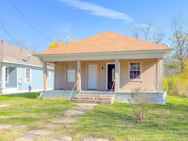 bungalow-style house with covered porch and a front lawn