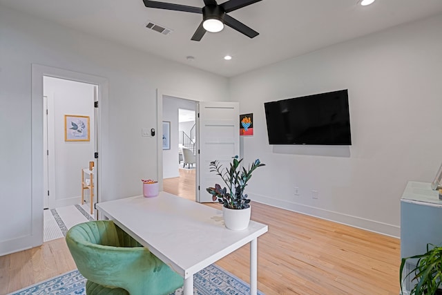 office space with ceiling fan and light hardwood / wood-style floors