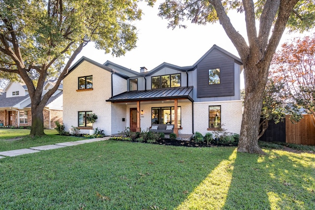 view of front facade with a front lawn and a porch