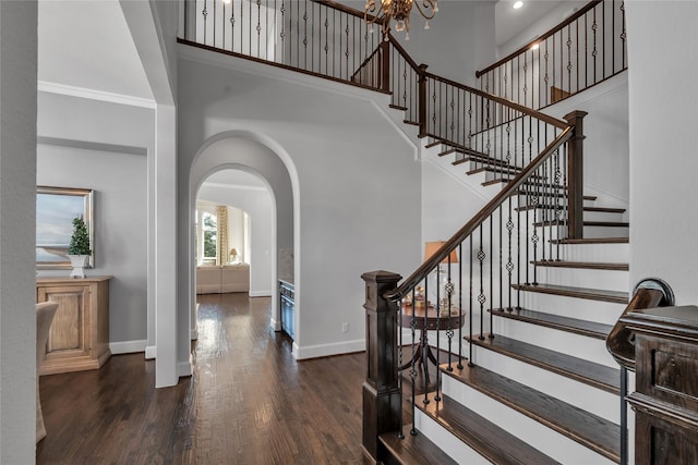 foyer with dark hardwood / wood-style flooring and crown molding