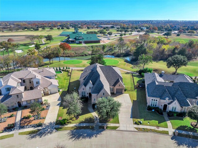 aerial view with a residential view, a water view, and golf course view