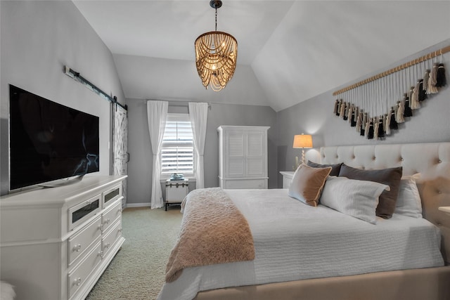 carpeted bedroom featuring a notable chandelier, vaulted ceiling, and a barn door