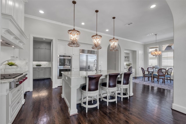 kitchen featuring an inviting chandelier, visible vents, appliances with stainless steel finishes, and dark wood-type flooring