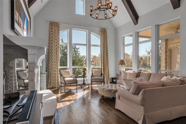 living room with decorative columns, a wealth of natural light, and high vaulted ceiling