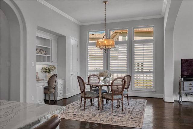 dining room with crown molding, an inviting chandelier, and dark hardwood / wood-style flooring