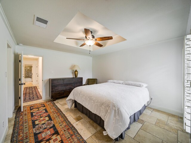 bedroom featuring a tray ceiling, ceiling fan, and crown molding