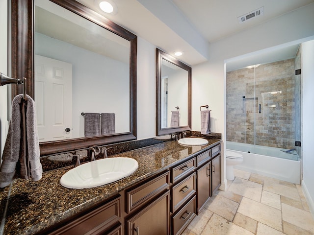 full bathroom featuring vanity, toilet, and enclosed tub / shower combo