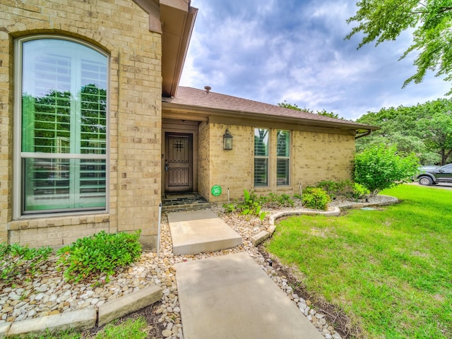 doorway to property featuring a yard