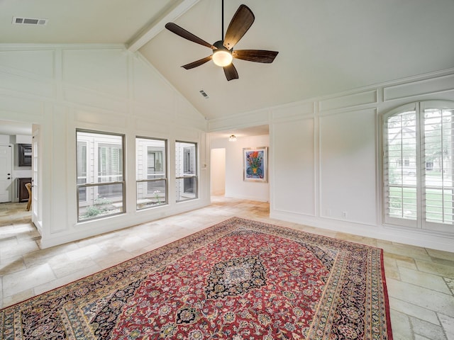 living room with beamed ceiling, ceiling fan, and high vaulted ceiling