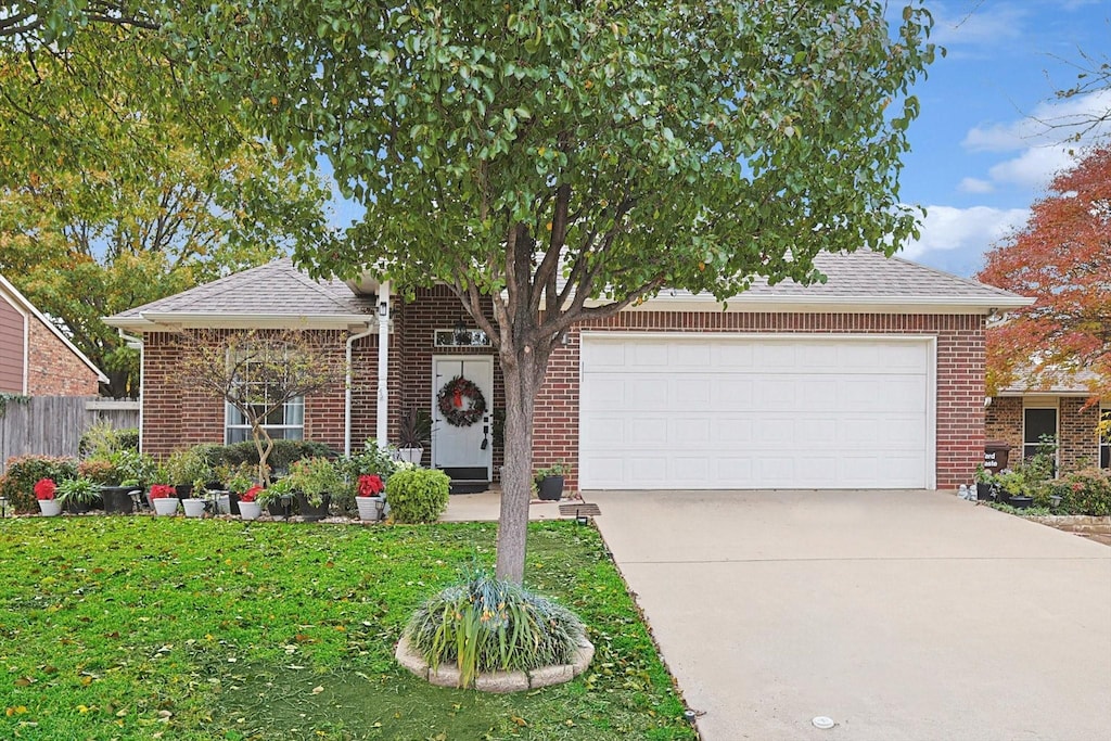 view of front of home with a garage and a front yard