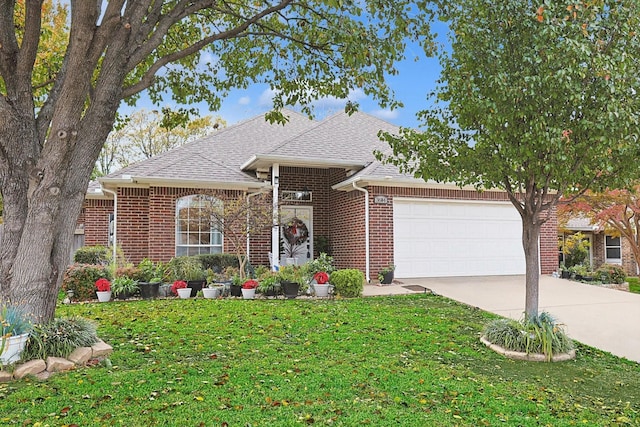 view of front of house featuring a front lawn and a garage