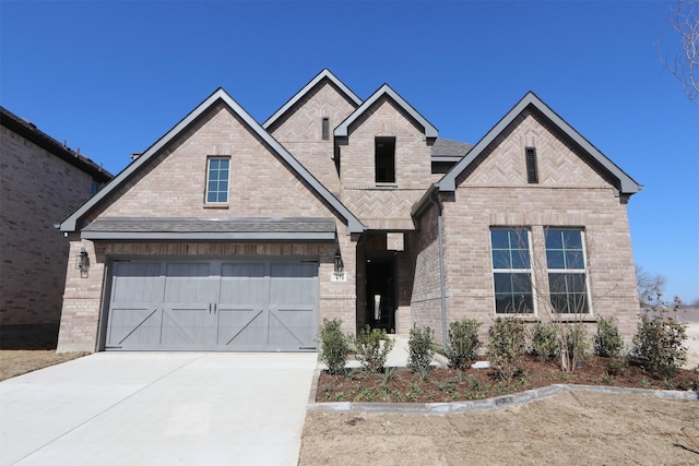 view of front of house with a garage, concrete driveway, and brick siding