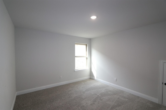 unfurnished room with carpet floors, recessed lighting, and baseboards