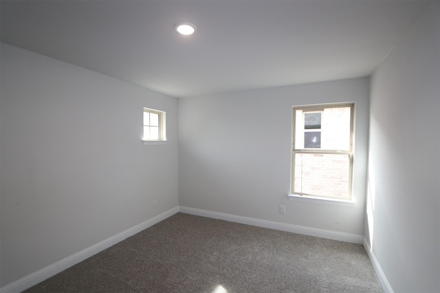 carpeted spare room with baseboards