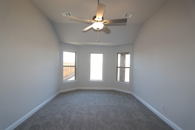 carpeted empty room featuring baseboards, vaulted ceiling, visible vents, and ceiling fan