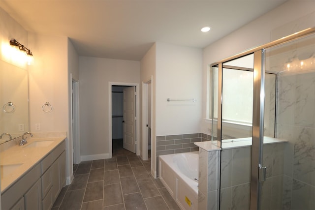 full bathroom featuring double vanity, recessed lighting, a stall shower, a sink, and a bath