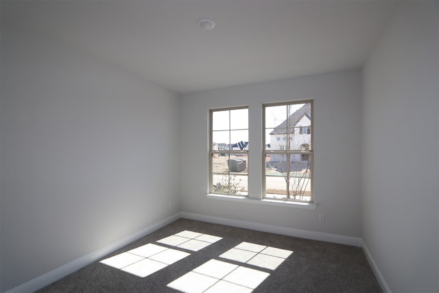 spare room with carpet flooring and baseboards