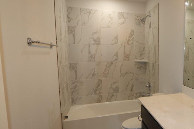 bathroom featuring washtub / shower combination, vanity, and toilet