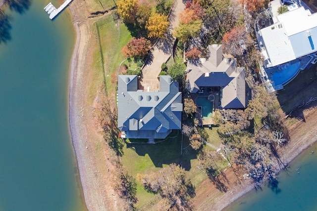 birds eye view of property with a water view and a beach view