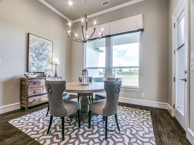 dining space with dark hardwood / wood-style floors, an inviting chandelier, and crown molding