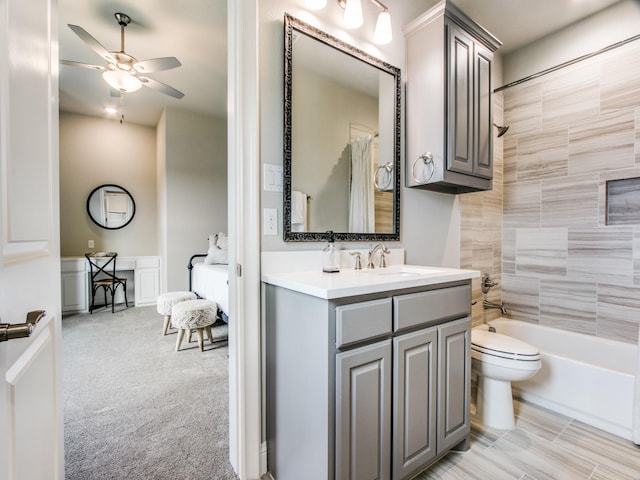 full bathroom with toilet, vanity, tiled shower / bath combo, and ceiling fan