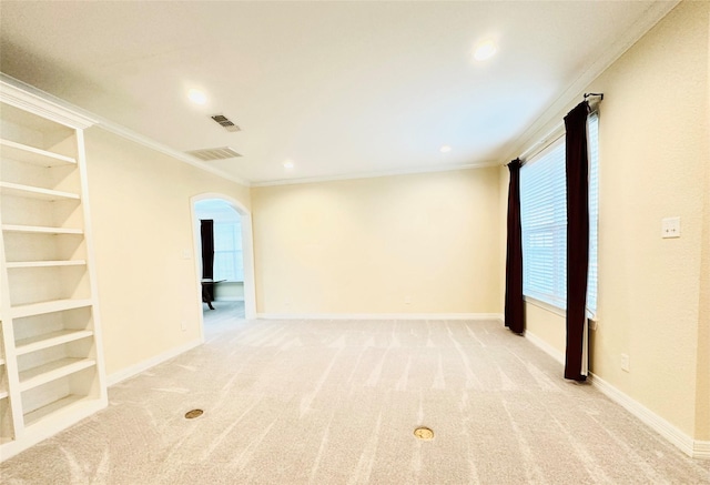 carpeted spare room featuring ornamental molding