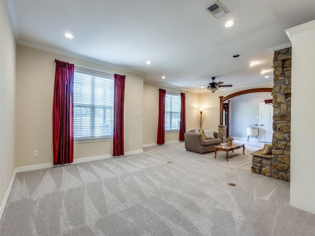 unfurnished living room featuring light carpet, crown molding, and ceiling fan