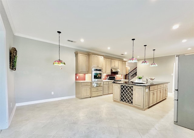 kitchen featuring light brown cabinets, stainless steel appliances, tasteful backsplash, decorative light fixtures, and a center island with sink