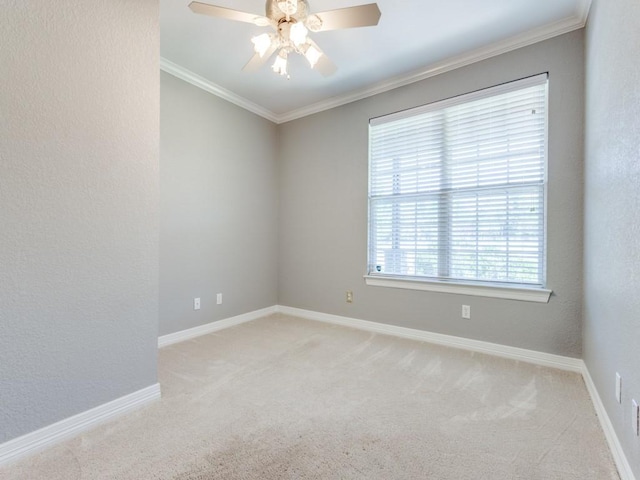 spare room with light carpet, ceiling fan, and ornamental molding