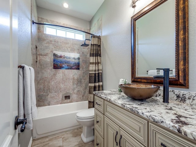 full bathroom featuring tile patterned flooring, shower / tub combo with curtain, vanity, and toilet