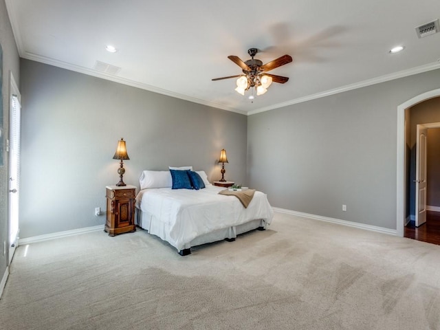 carpeted bedroom featuring ceiling fan and ornamental molding