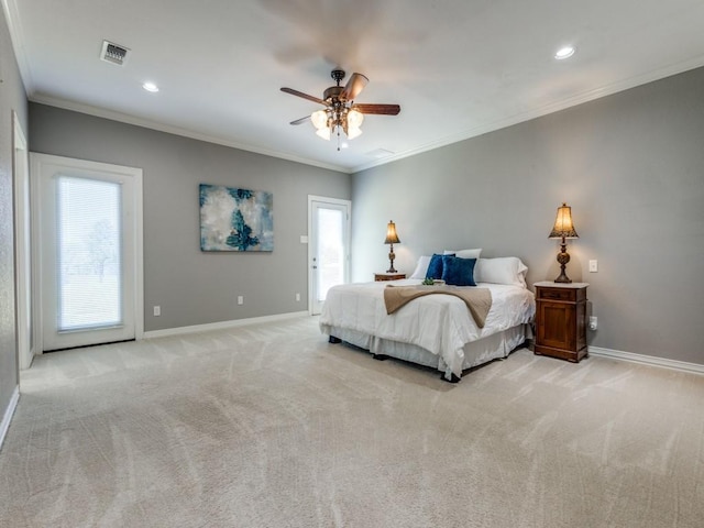 carpeted bedroom with ceiling fan and ornamental molding