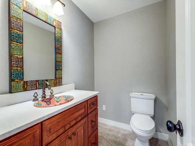 bathroom with tile patterned floors, vanity, and toilet