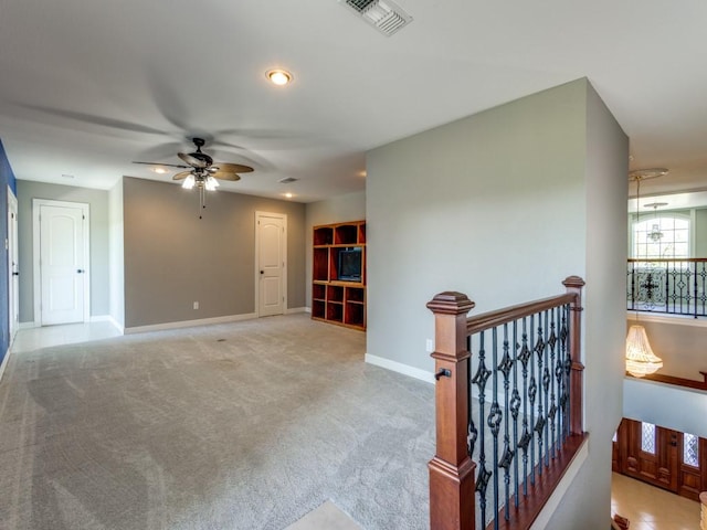 carpeted spare room with ceiling fan