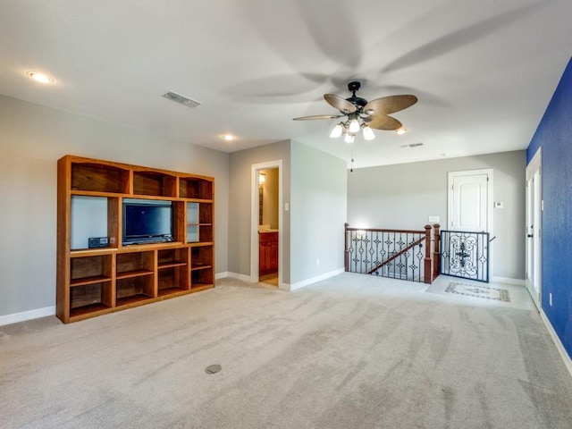 unfurnished living room featuring ceiling fan and light colored carpet