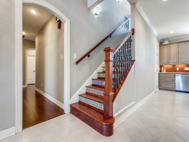 stairs with hardwood / wood-style flooring and crown molding