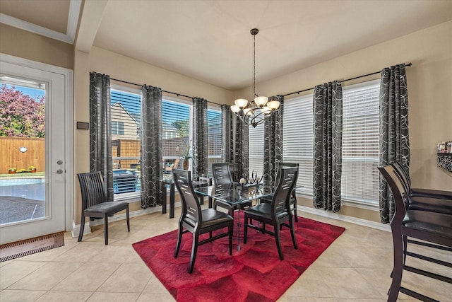 tiled dining area with a chandelier