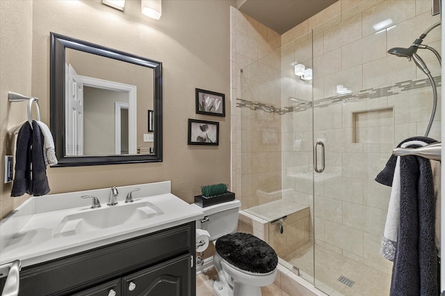 bathroom featuring an enclosed shower, vanity, and toilet