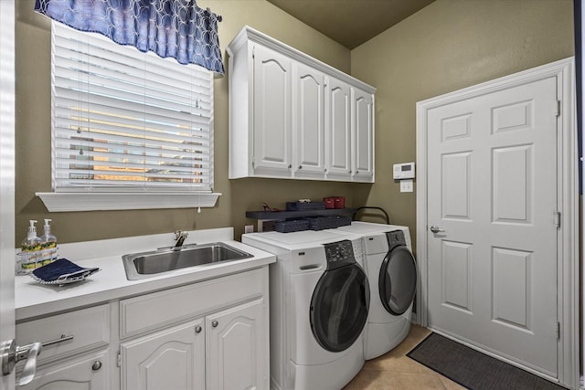 laundry area with cabinets, sink, light tile patterned floors, and washer and clothes dryer