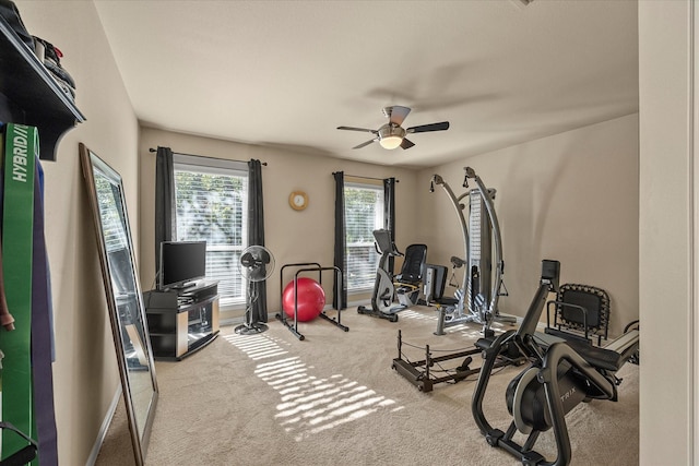 exercise room featuring ceiling fan and light colored carpet