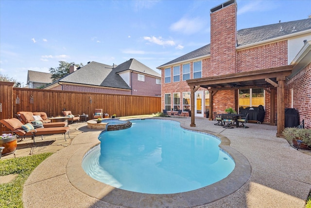 view of pool with grilling area, a patio, and an in ground hot tub