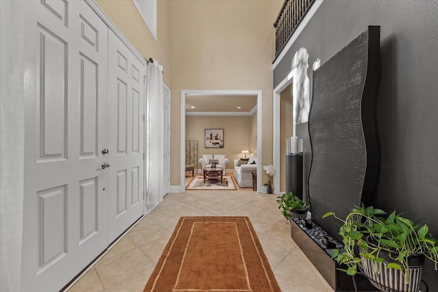 corridor featuring a high ceiling and light tile patterned floors