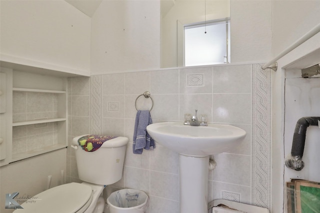 bathroom with toilet, tile walls, and walk in shower