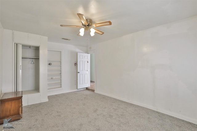 unfurnished bedroom featuring a closet, ceiling fan, and light colored carpet